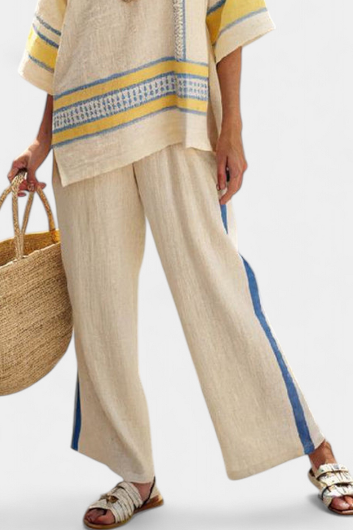 Stylish women's blue-yellow Mediterranean summer set. Comfortable, multi-colored flowy top & wide-leg pants outfit.