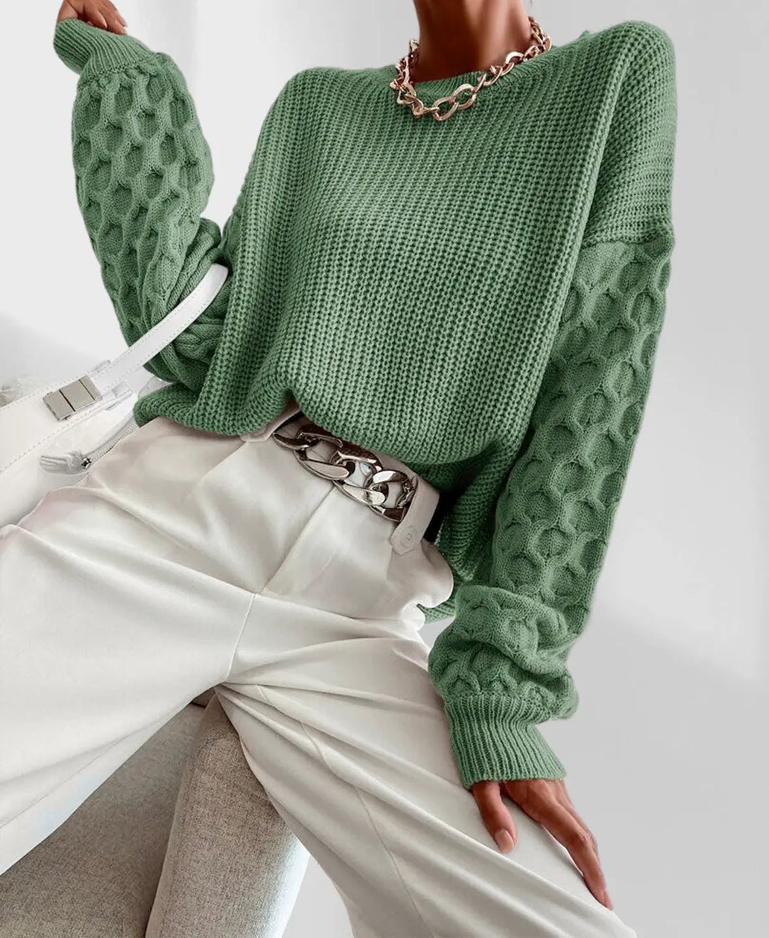 Women's spring knit sweater styled with jeans, a chic and cozy casual outfit. Fashionable pullover.