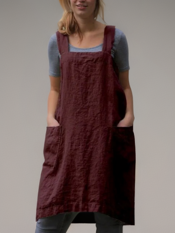 Women's cross-back apron dress with multiple deep pockets, perfect for keeping tools & essentials handy.