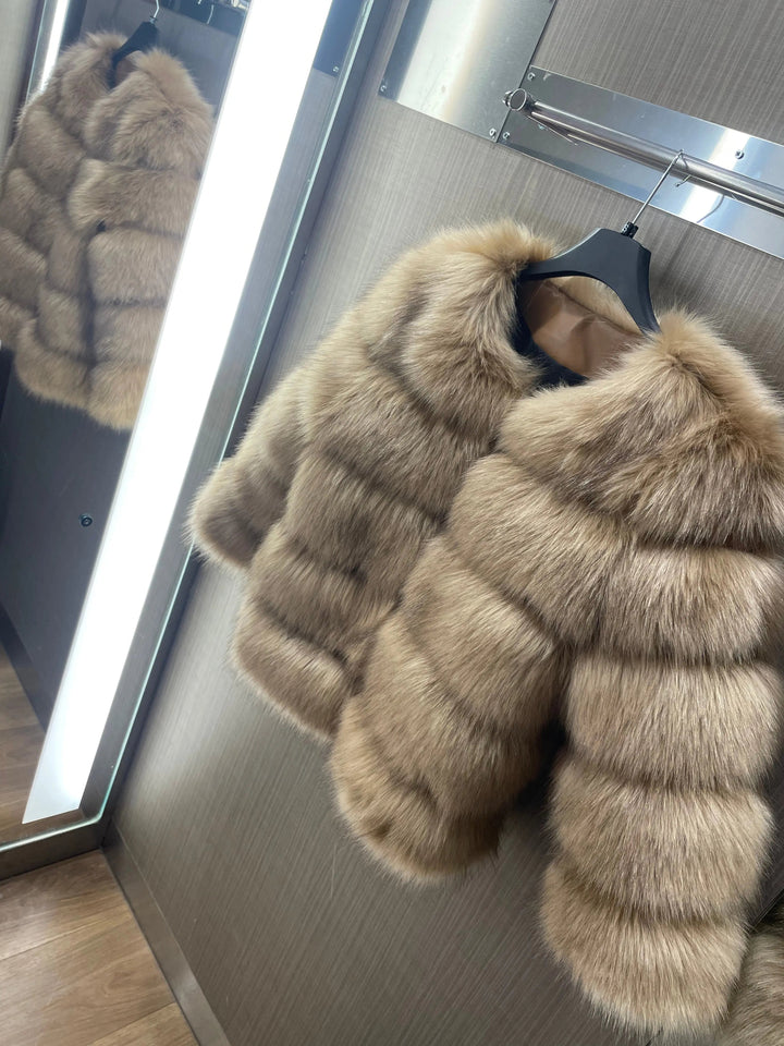 Women's elegant winter coat in a snowy setting, stylish cold weather outerwear for chic fashion.