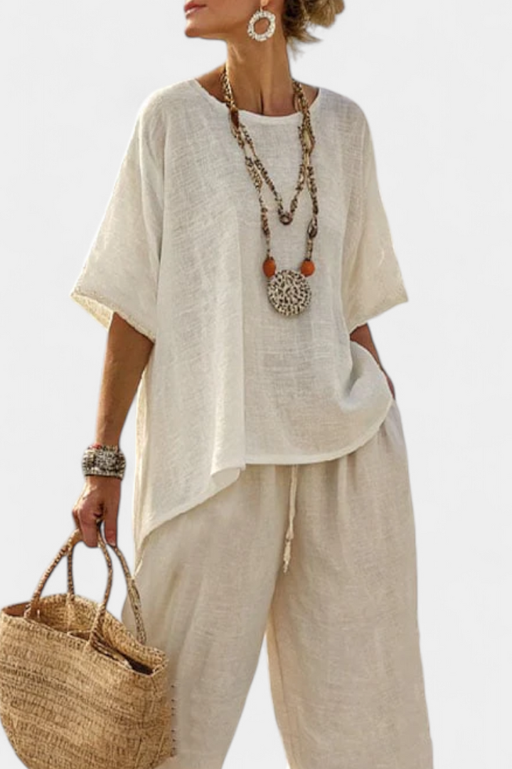 Chic women's white minimalist blouse and wide-leg pants set, a versatile two-piece outfit for casual or lounge wear.