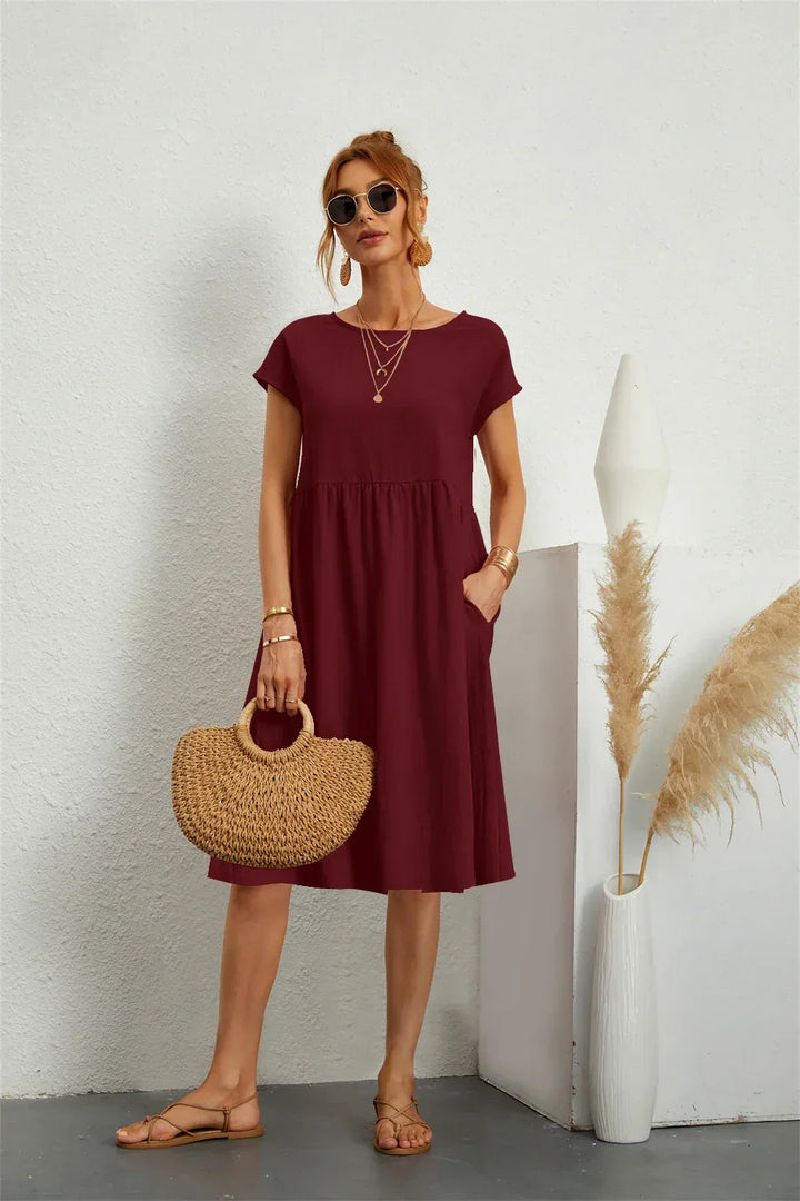 Loose-fit women's casual midi dress, stylish and comfortable with practical pockets for everyday.