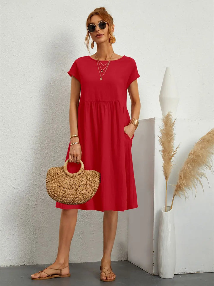 Stylish women's midi dress with pockets, versatile for spring and summer casual wear.