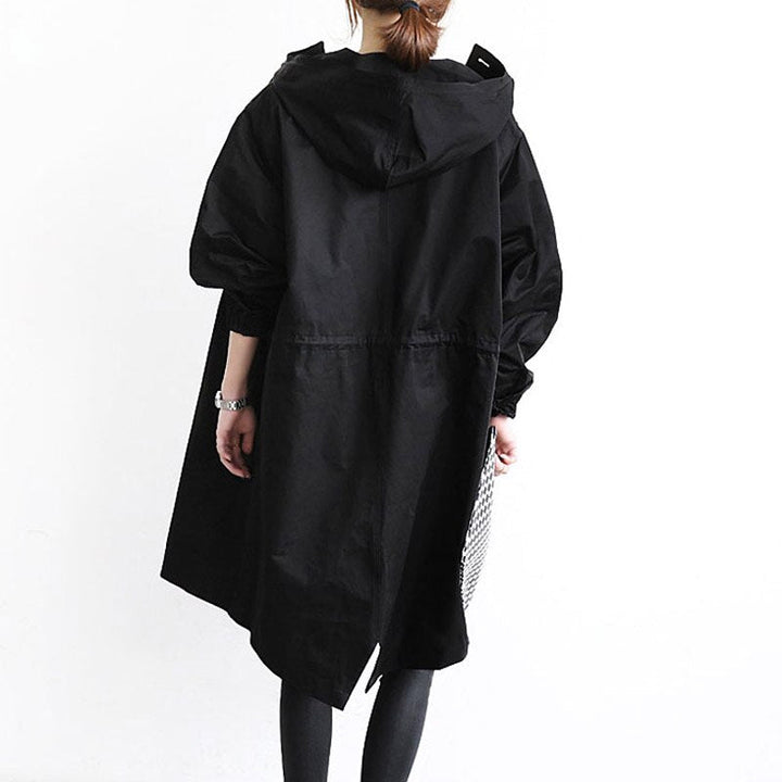 Versatile women's waterproof trench coat. Stylish classic outerwear, ideal for elegant fall and spring fashion.