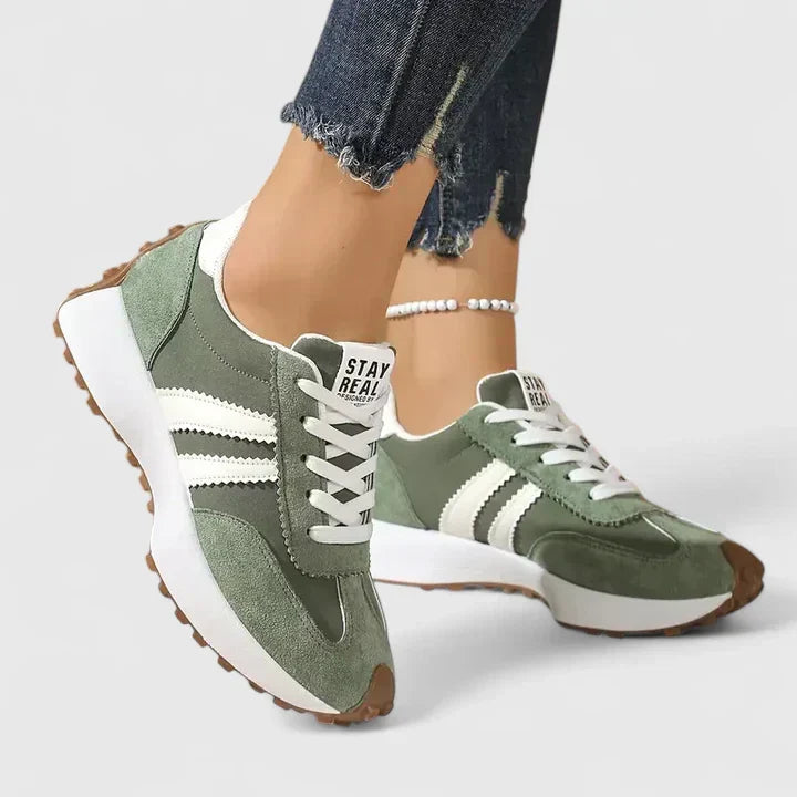 Stylish green women's trainers offering orthopaedic arch support, perfect for comfortable walking & casual wear.