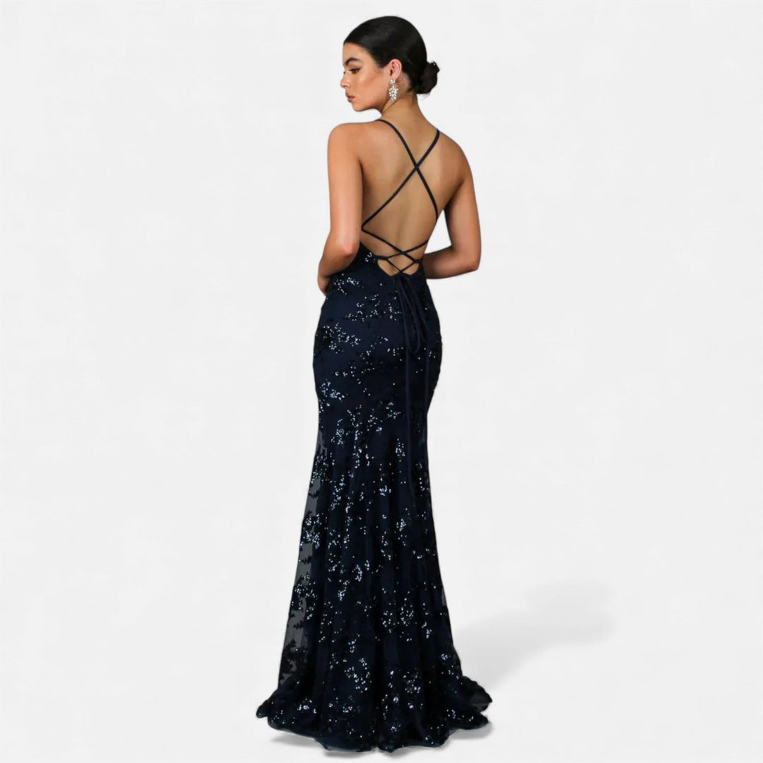 Woman wearing an elegant sequin maxi dress, a glamorous evening gown for formal events, parties & special occasions.