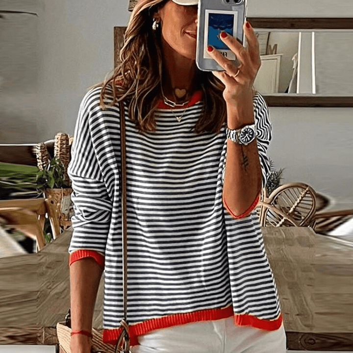 Comfortable women's blue striped sweater with unique orange trim detail, a versatile long-sleeve top for casual or chic outfits.