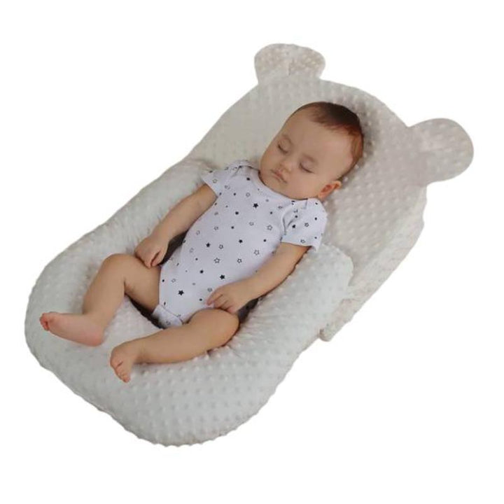 Portable anti-reflux nursing cushion for infants, offering adjustable support for secure, easy baby feeding care.