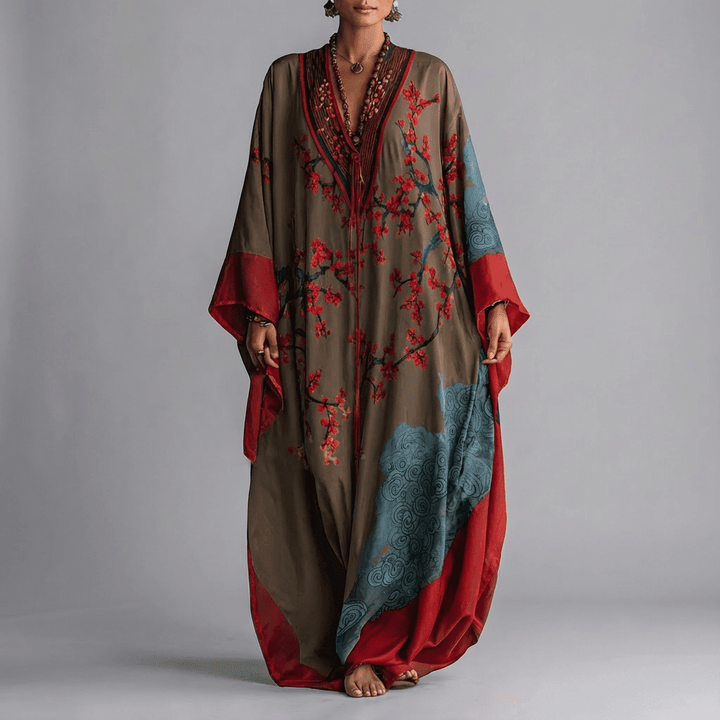 Elegant women's beige floral maxi dress with distinctive batwing sleeves, featuring a pretty plum blossom print.