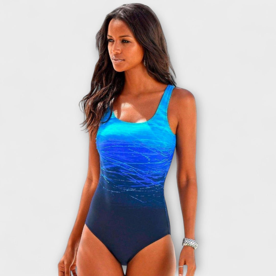 Women's active fit one-piece swimsuit with vibrant gradient design, perfect for swimming & sporty beachwear.
