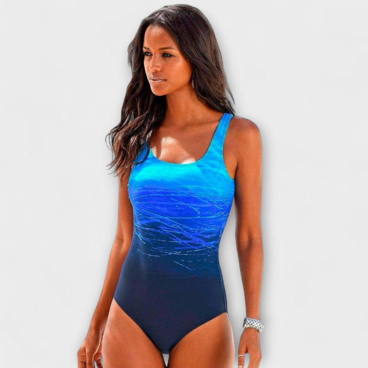 Women's active fit one-piece swimsuit with vibrant gradient design, perfect for swimming & sporty beachwear.