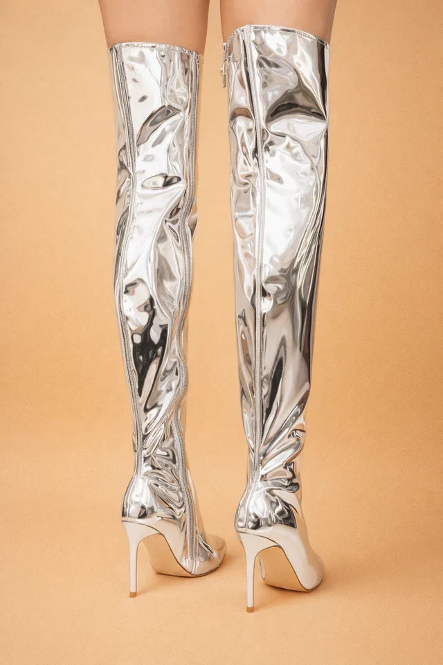 Striking silver over-the-knee boots for women, designed with a pointed toe to elevate any outfit.