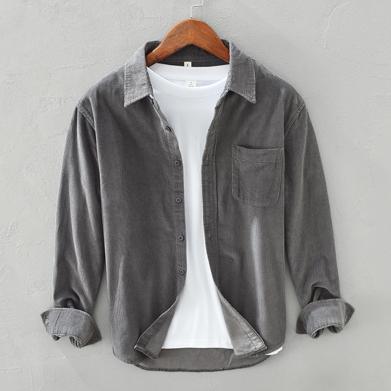 Folded men's retro style button-down shirt, ready for comfortable casual wear. Elegant long sleeve men's fashion top.