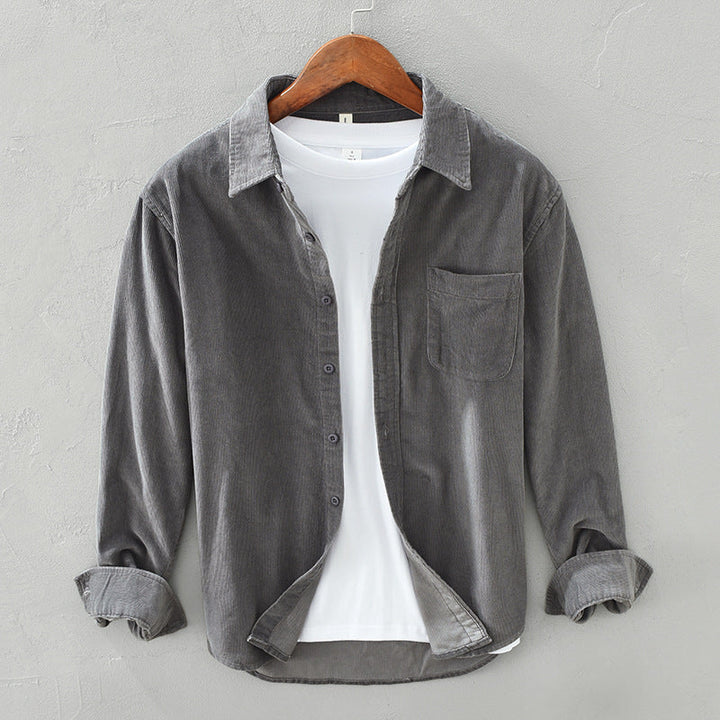Folded men's retro style button-down shirt, ready for comfortable casual wear. Elegant long sleeve men's fashion top.