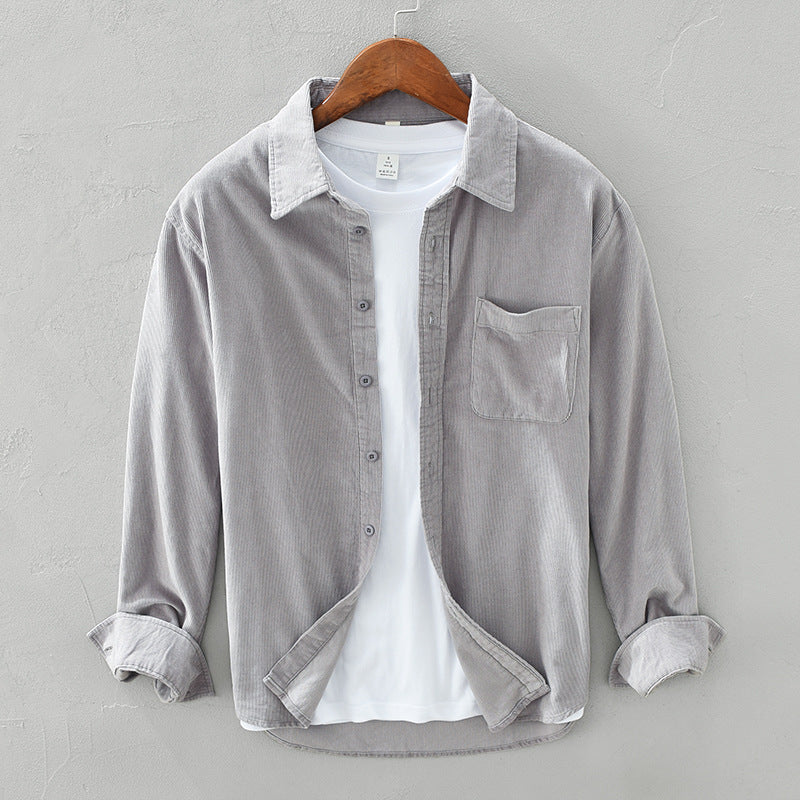 Close-up of men's comfortable retro style long sleeve shirt fabric, showing elegant button-down details. Quality men's top.
