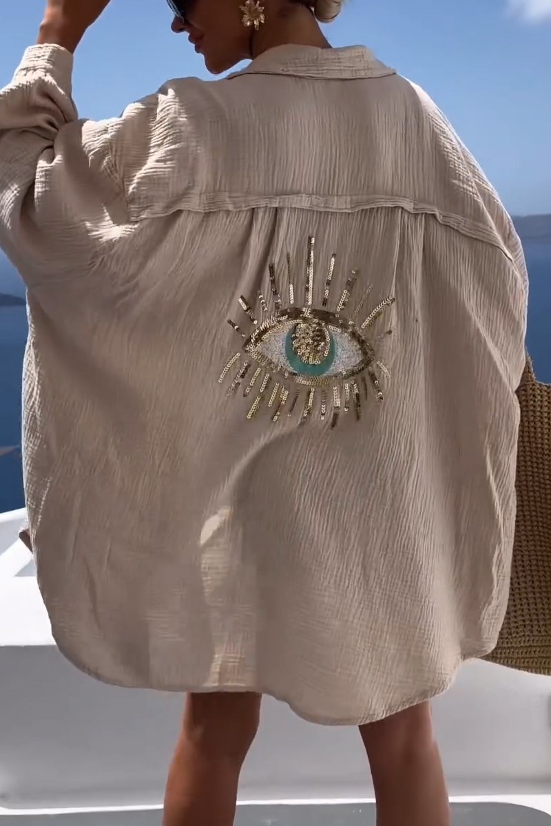 Women's Nora oversized blouse with eye pattern, a versatile button-down top for relaxed spring & summer holiday fashion.