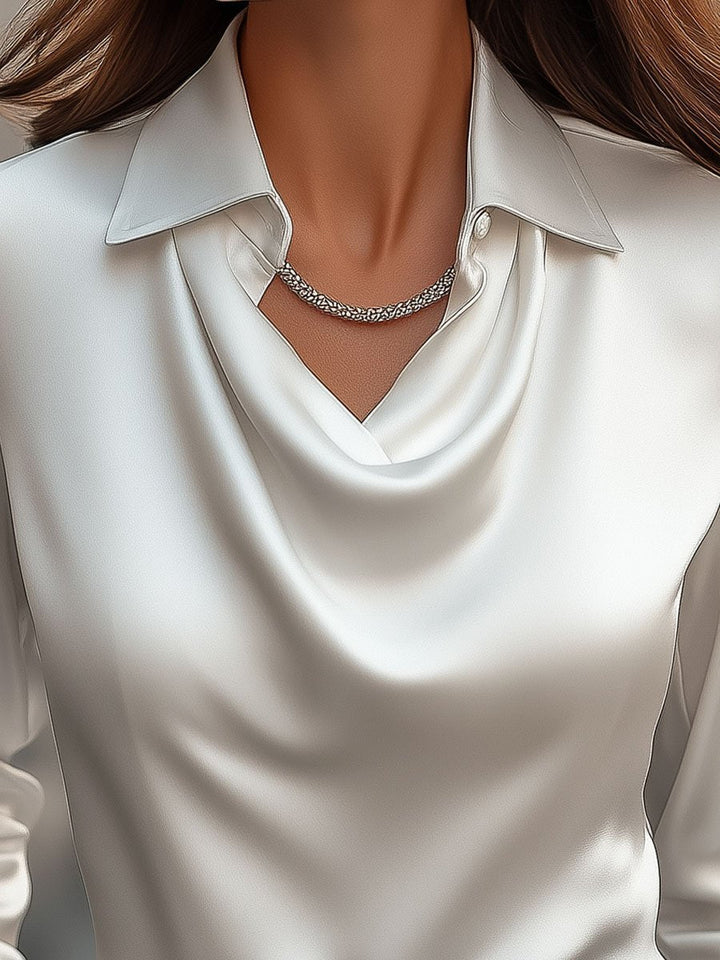 Chic long-sleeve women's blouse, featuring a stylish draped neck. Ideal for elegant workwear.