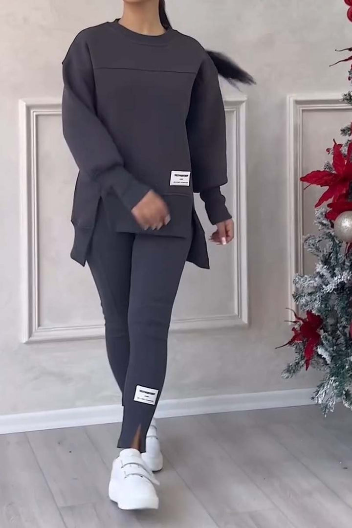 Model wearing a women's oversized loungewear set: cozy long-sleeve crew neck sweater & comfortable leggings for home.
