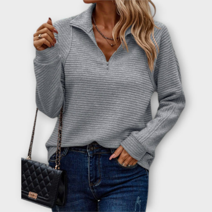 Soft knit women's V-neck jumper with stylish zipper. Comfortable long sleeve pullover for everyday wear.