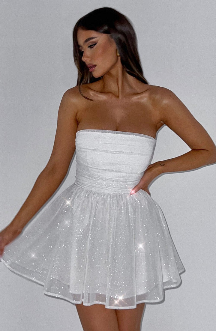 Close-up of elegant women's strapless mini dress, showing A-line flare and delicate fabric detail.