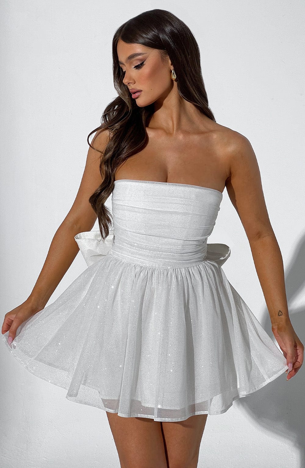 Model wearing a women's strapless A-line mini party dress, showcasing its elegant flared design.