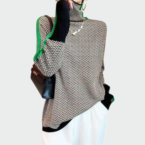 Close-up of a women's herringbone turtleneck sweater, showcasing its unique pattern and soft texture.