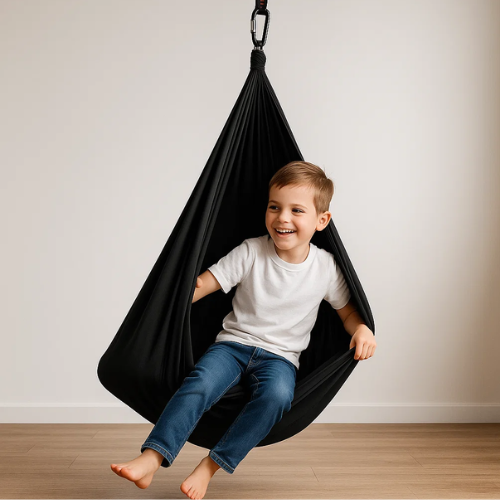 Child enjoying a calming sensory swing, providing comfort & a quiet space for play and developmental support.
