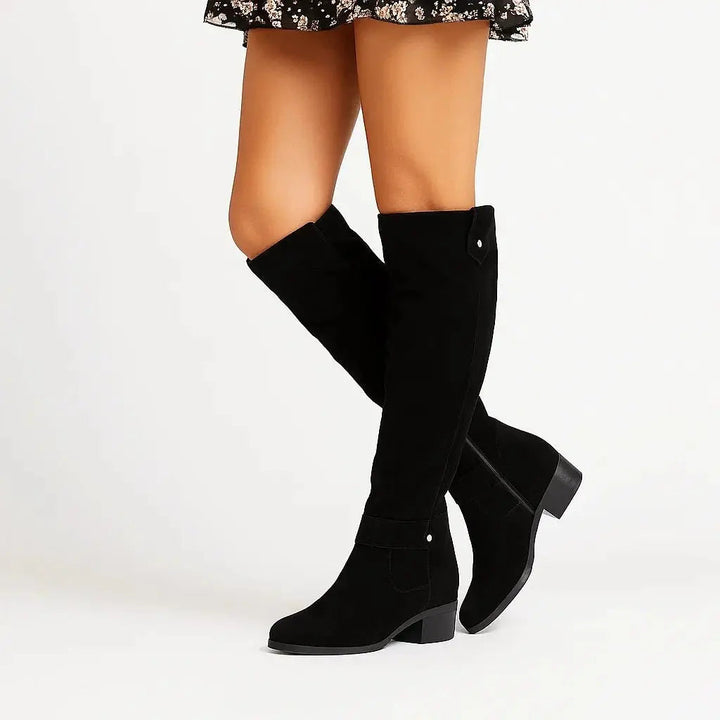 Classic black knee-high suede boots for women, designed with a comfortable block heel and practical side zip for style.