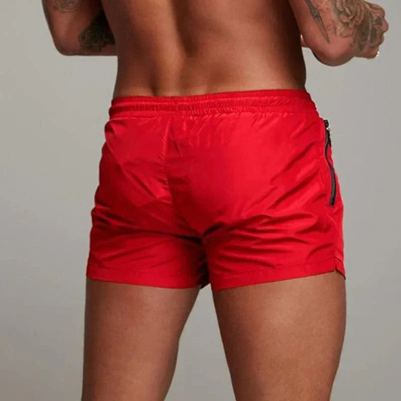 Men's stylish short swim trunks with pocket for beach & pool. Quick-dry swimwear for summer fun.