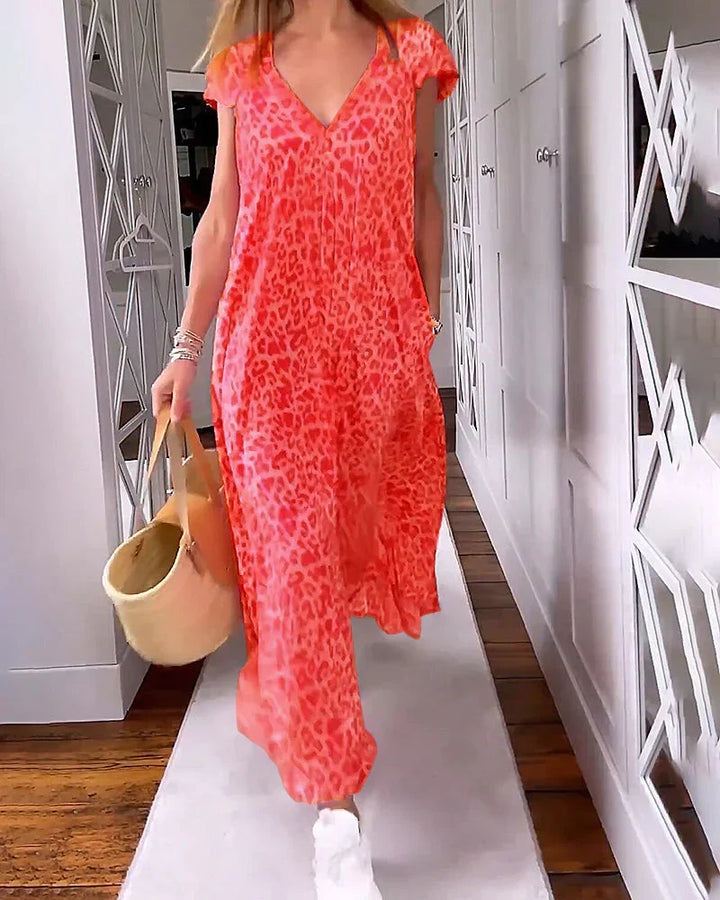 Chic plus size V-neck maxi dress featuring a beautiful print and short sleeves; an elegant and comfy summer choice.