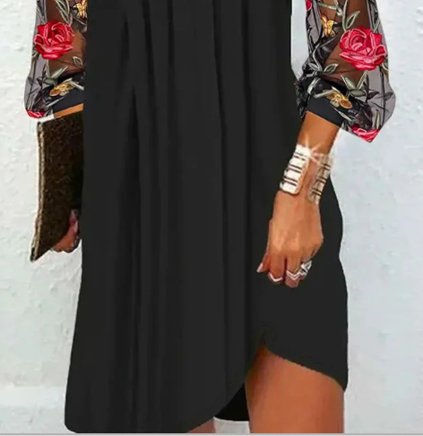 Women's elegant black dress with unique floral embroidered sleeves, a timeless V-neck design for evening fashion.