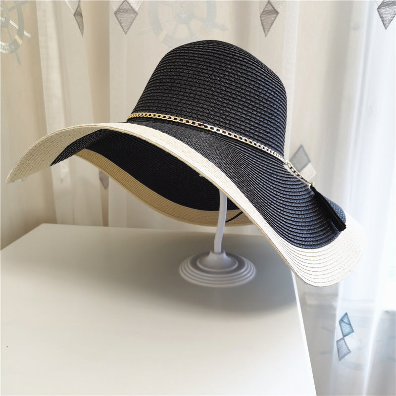 Stylish women's wide brim straw sun hat with two-tone design, ideal for summer style and sun protection.