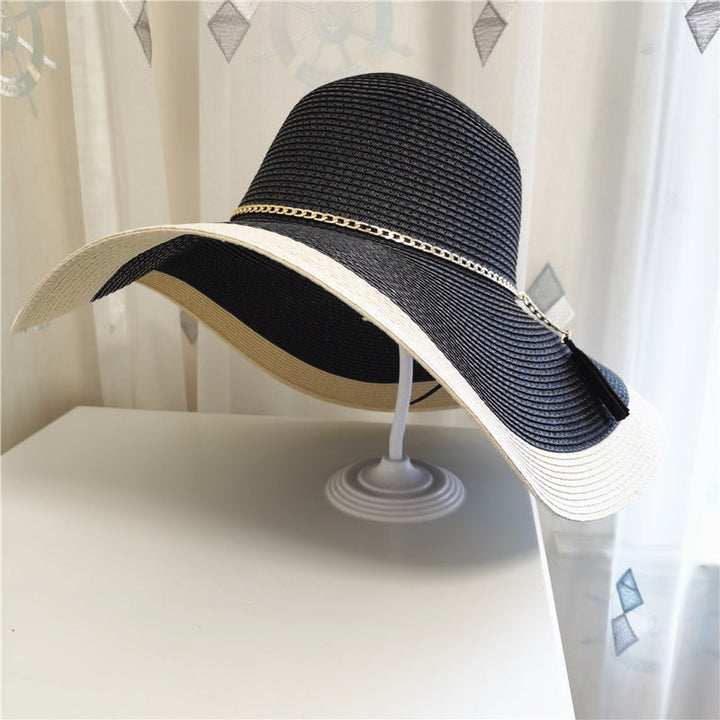 Stylish women's wide brim straw sun hat with two-tone design, ideal for summer style and sun protection.