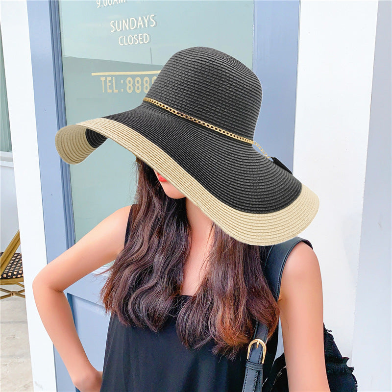 Women's chic two-tone wide brim straw sun hat, perfect for beach, resort, or summer travel fashion.