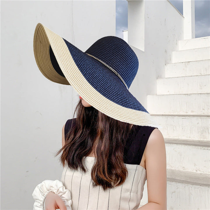 Close-up of a women's two-tone wide brim straw sun hat, showcasing its unique texture and chic design.