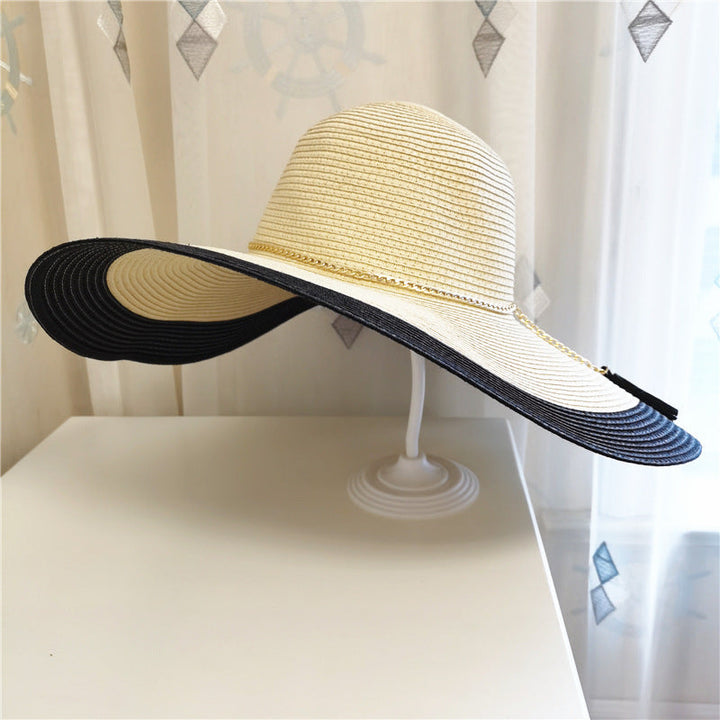 Fashionable women's wide brim two-tone straw hat, essential summer accessory for sun protection & style.