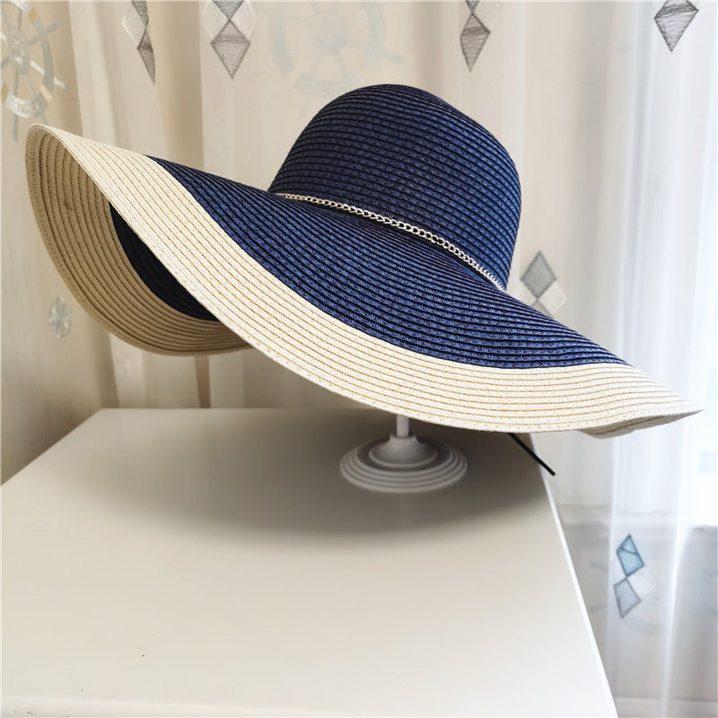 Elegant two-tone straw sun hat for women, featuring a wide brim, great for beachwear and resort fashion.