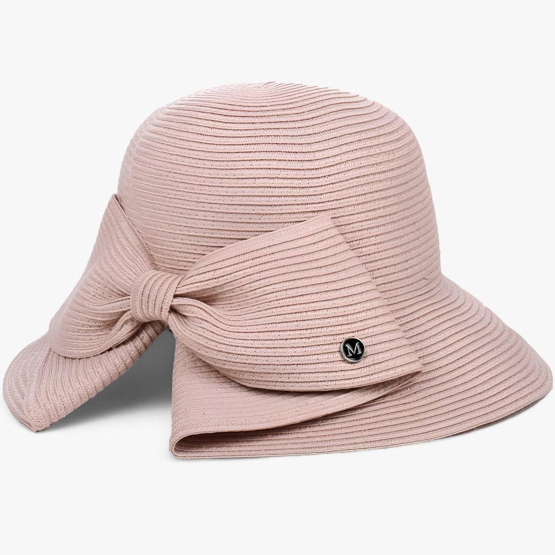 Chic women's straw sun hat with asymmetrical bow, essential for beach vacations & elegant travel.