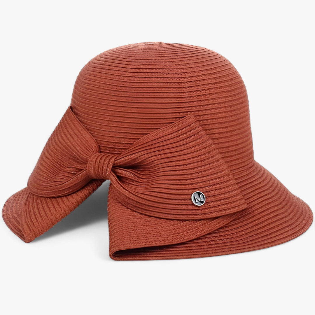 Fashionable women's straw sun hat with asymmetrical bow for sun protection and elegant summer style.