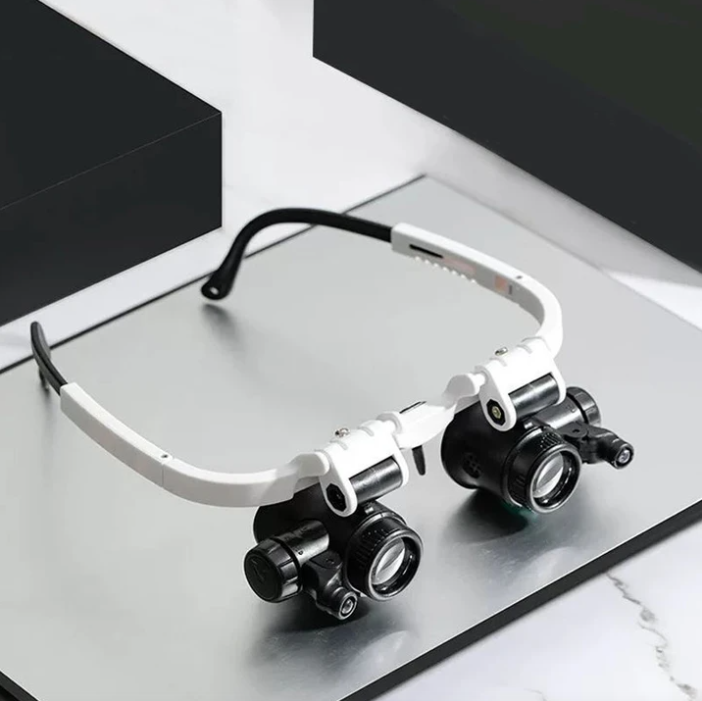 "LED-lit magnifier glasses with adjustable headband and up to 23x magnification for precision tasks and comfort."