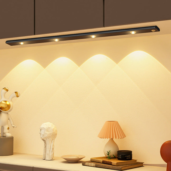 "LED motion sensor under cabinet light with cat-eye bulb, adjustable luminance, and magnetic installation in kitchen setting.