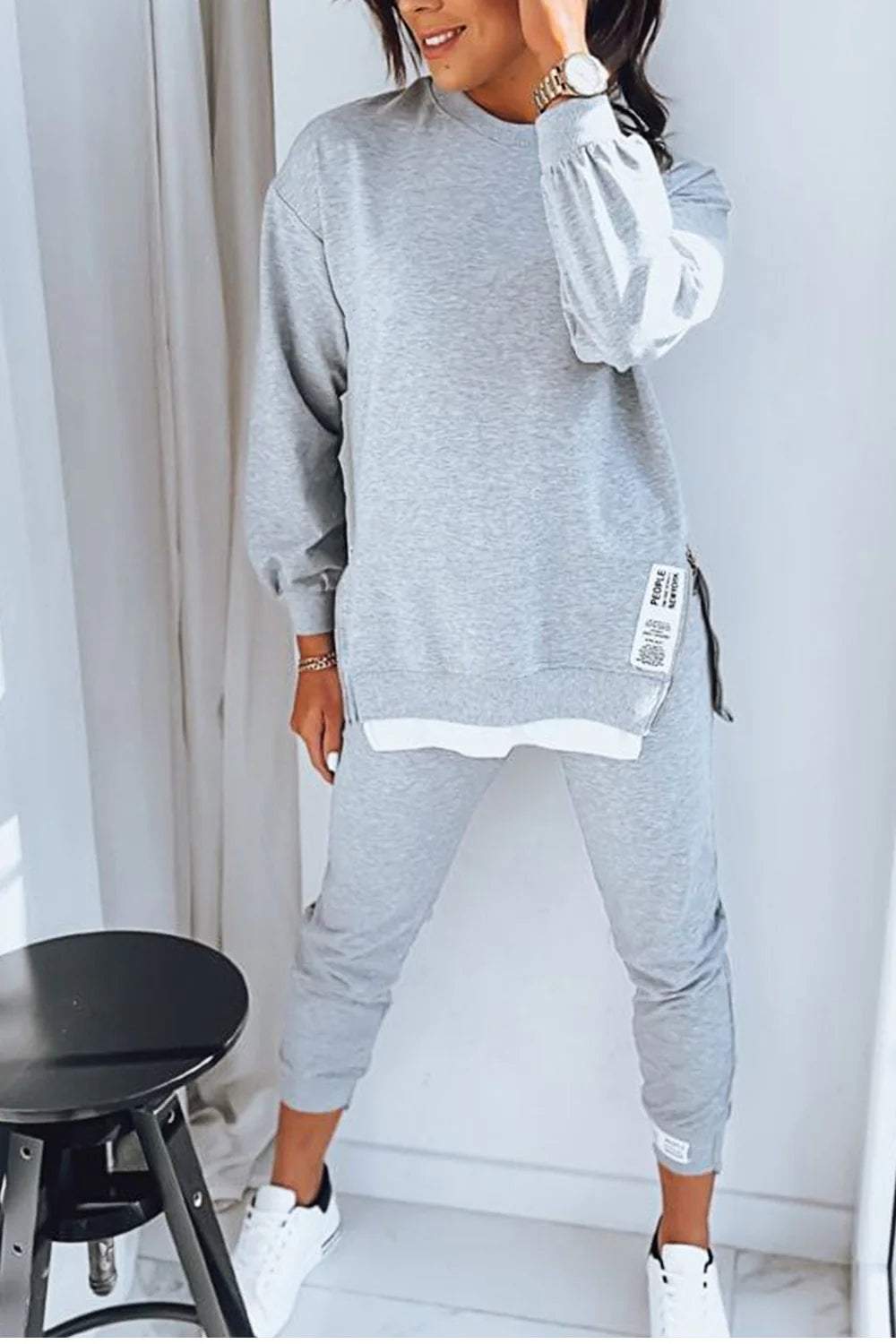 Stylish women's cozy sweatshirt and pants set, perfect for home relaxation or casual fashion.