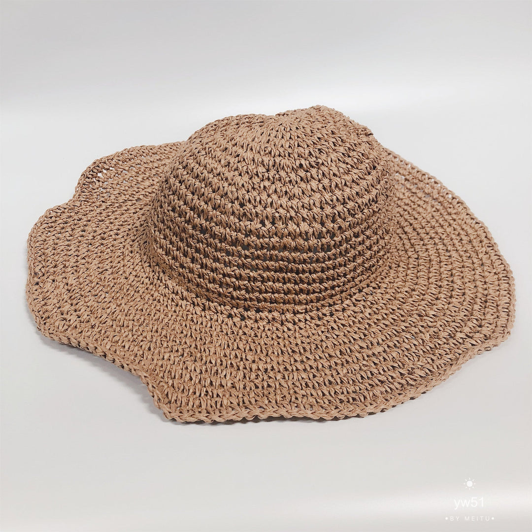Hand-crocheted women's straw bucket hat with a wide brim, designed for ultimate summer sun protection.
