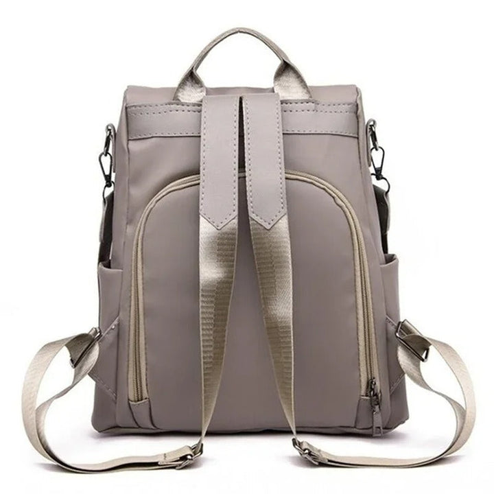 Durable water-resistant nylon women's backpack, lightweight and minimalist for travel or daily commutes.