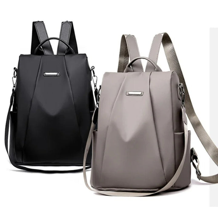 Sleek women's water-resistant nylon backpack. Lightweight, minimalist design with multi-way carry for modern life.