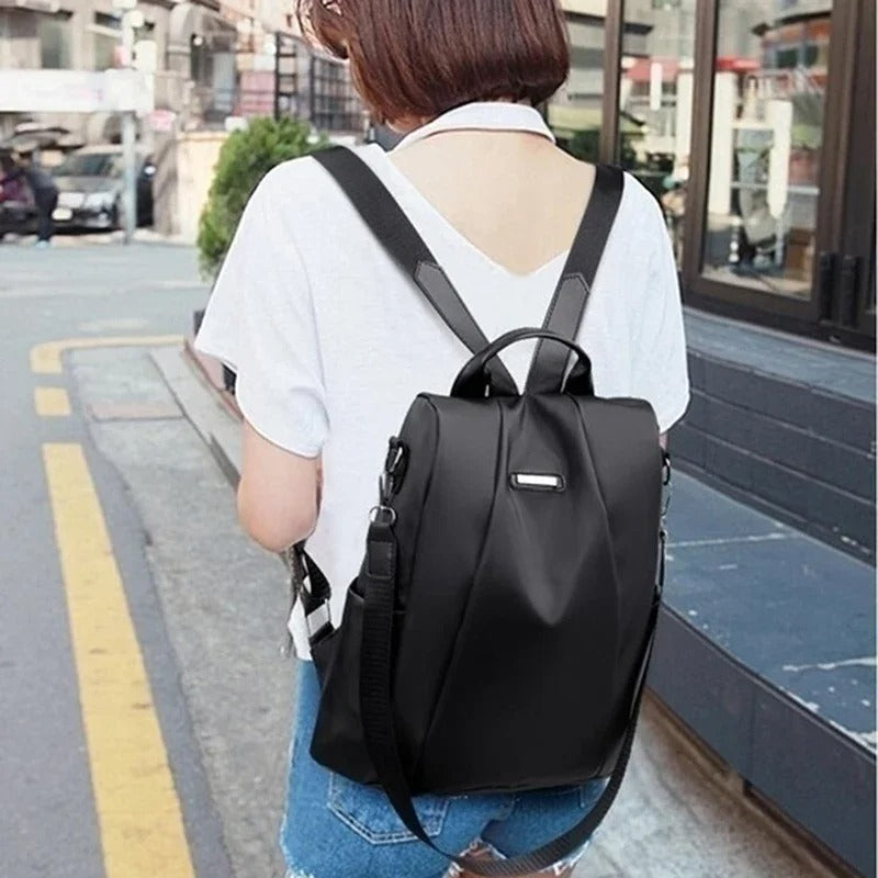 Practical women's lightweight nylon backpack. Water-resistant, multi-way design for everyday use & travel convenience.