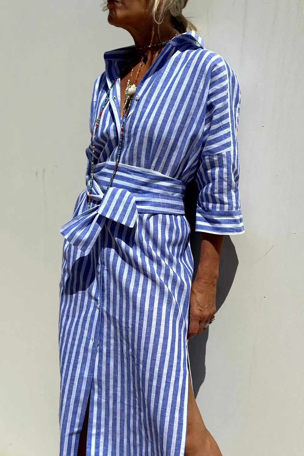 Casual women's striped midi dress featuring a classic button-down design and comfortable fit.