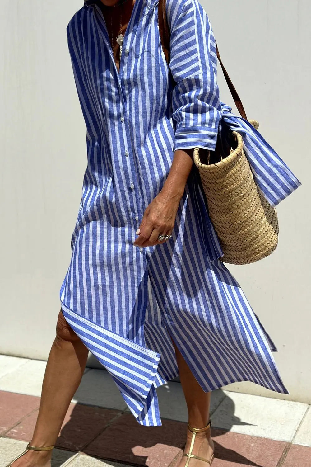 Fashionable women's collared midi shirt dress in a chic stripe pattern, perfect for everyday wear.
