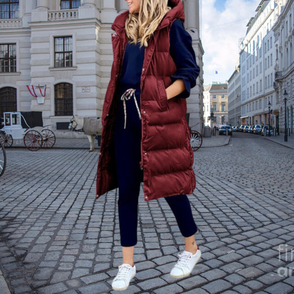 Elegant women's hooded long gilet, a versatile padded vest for layered fashion and casual winter outfits.