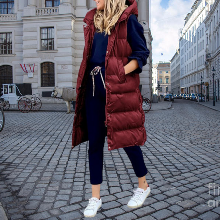 Elegant women's hooded long gilet, a versatile padded vest for layered fashion and casual winter outfits.